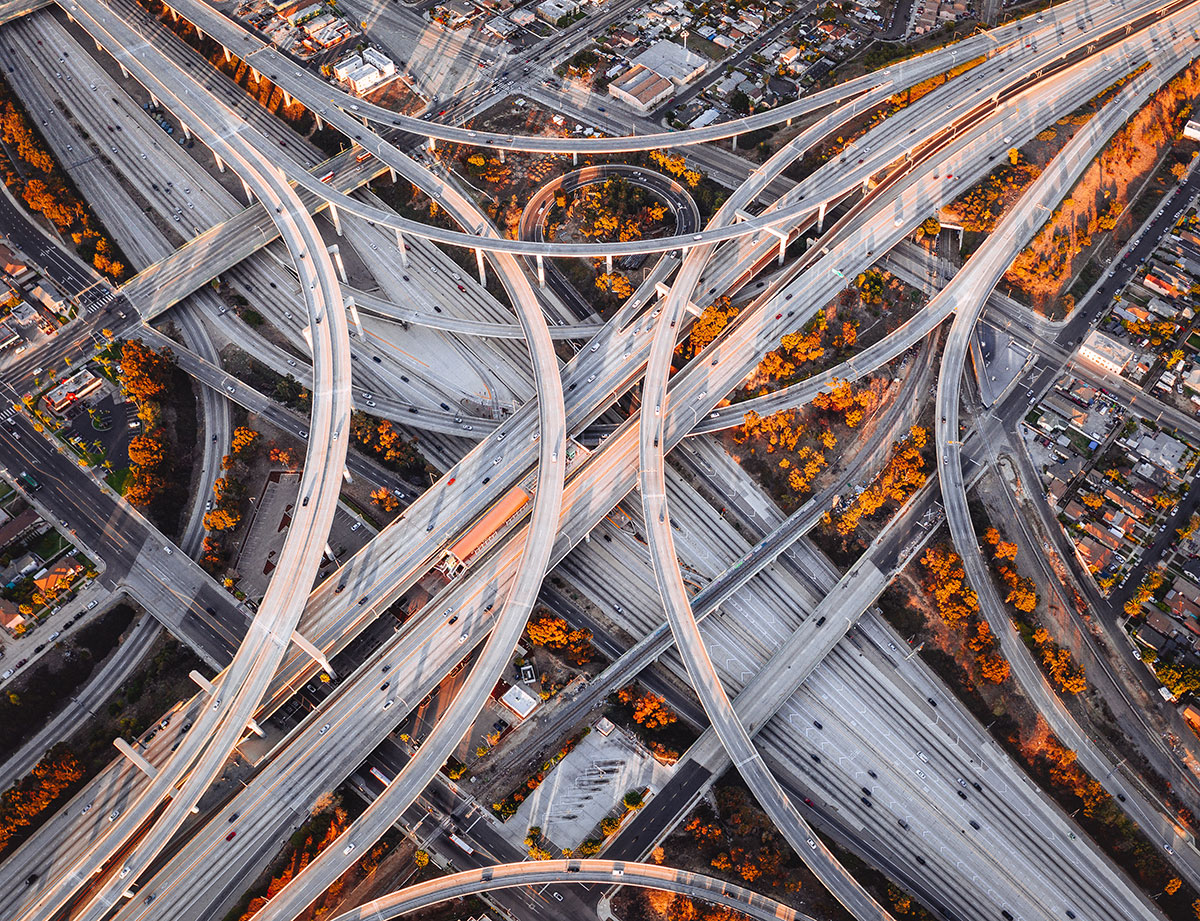 Highway system with multiple vehicles representing an internet connection. The vehicles read "data" on the side, to represent data packets, being transported to and from a distant city (the server you're connecting to).